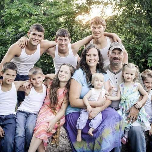 Michael and Amber Leathers with children at C4 Farms El Dorado Springs Missouri — early farm years, baby Zadok in arms
